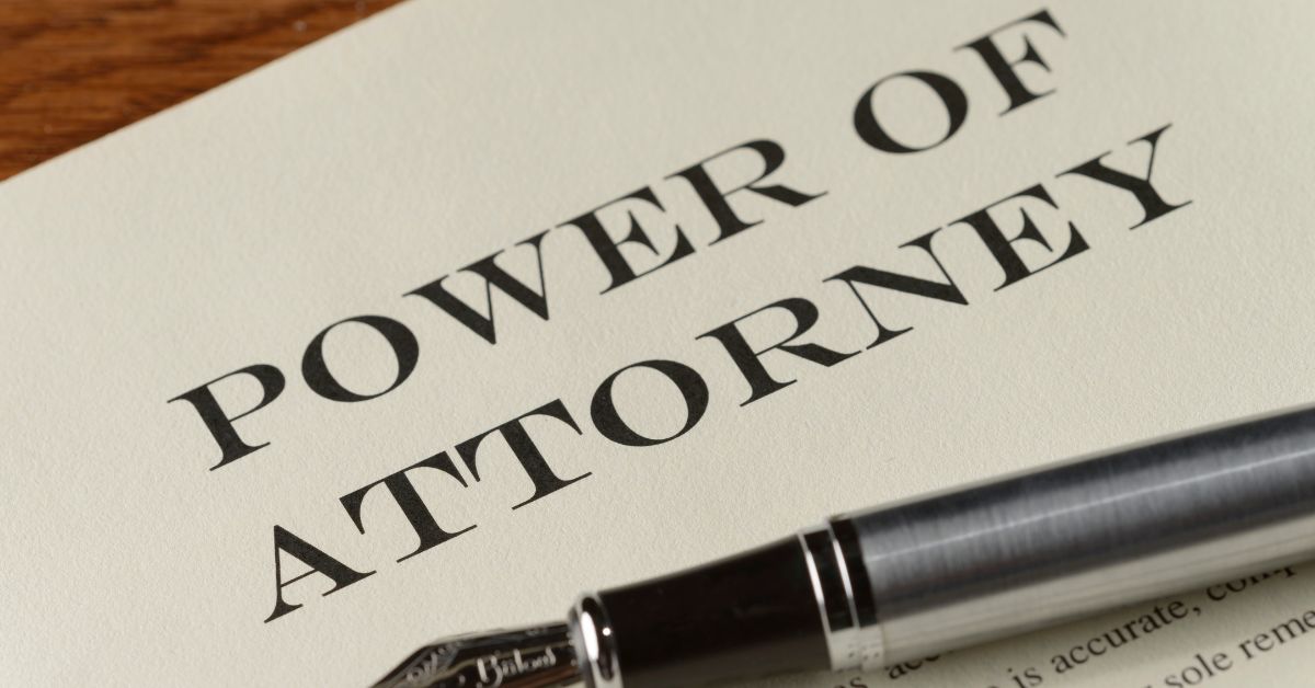 Power of attorney document with a pen laying on top of the paper.